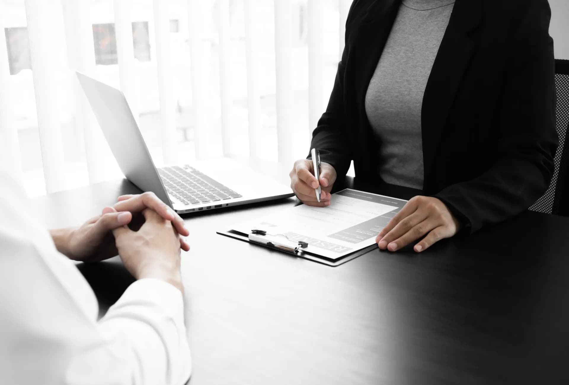 Business Central services team collaborating around a laptop